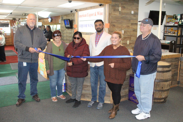 Owners of American Liquor and Wine were joined by the Goddard Chamber of Commerce for a recent ribbon- cutting. The newly-renamed store is located on Goddard's west edge.